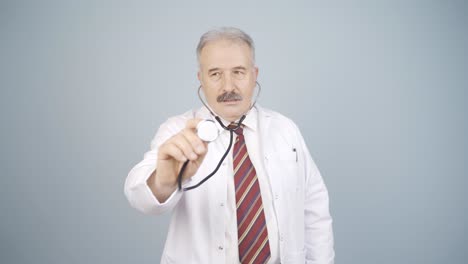 Doctor-listening-to-camera-with-stethoscope.